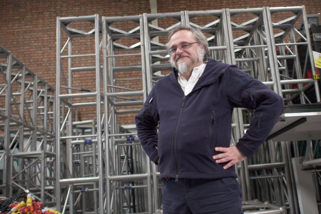 a man standing in front of some metal scaffolding