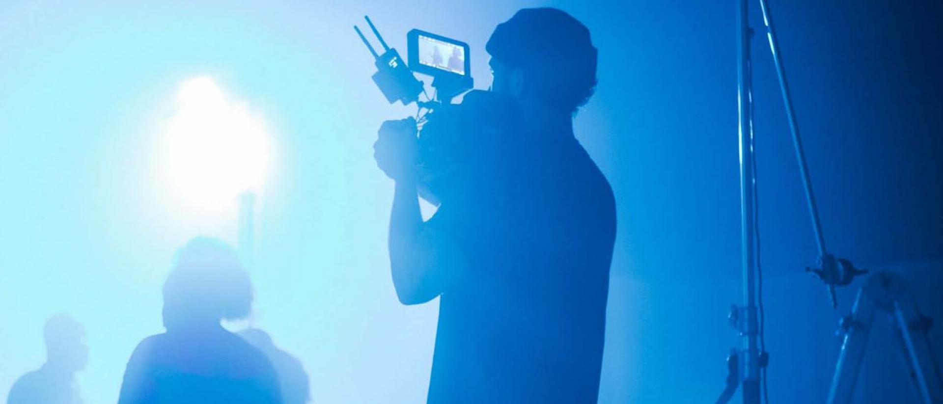 a person on a film set holding a camera