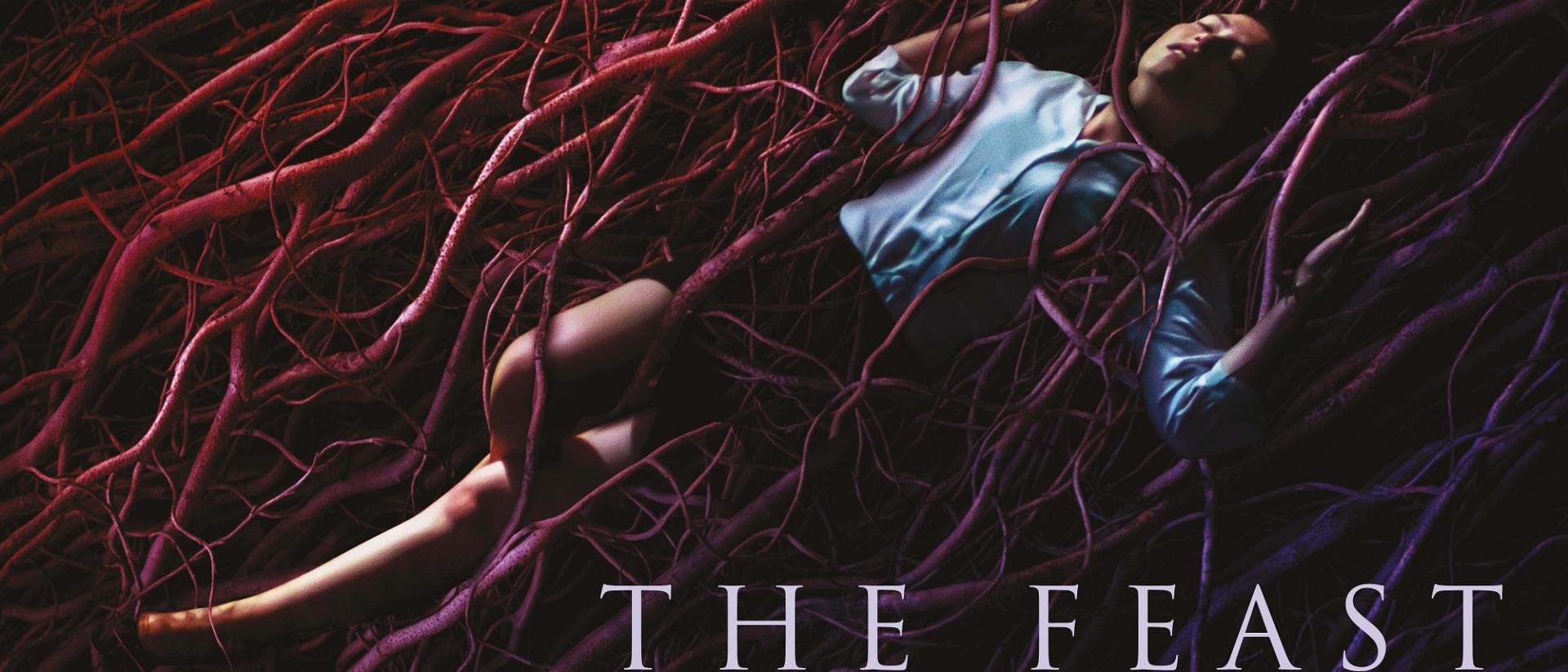 poster for the feast featuring annes elwy lying back in a nest of tree roots.