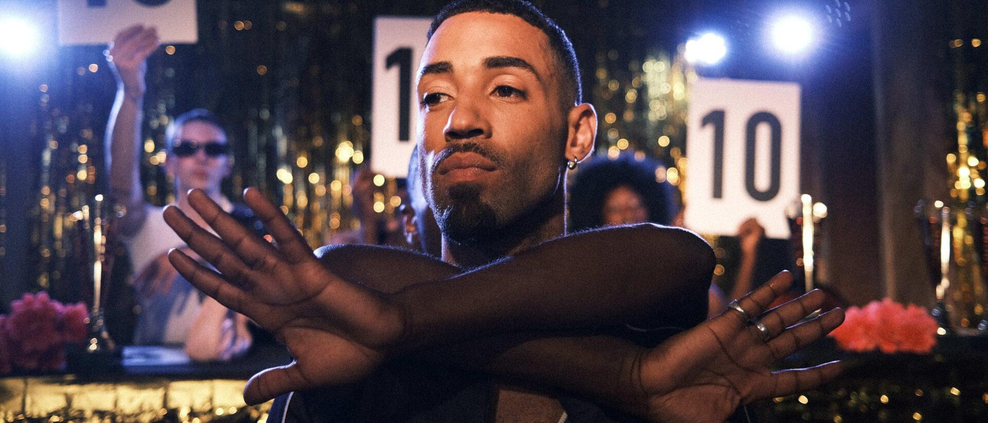 a person performing a dance with judges holding up '10' scorecards behind them