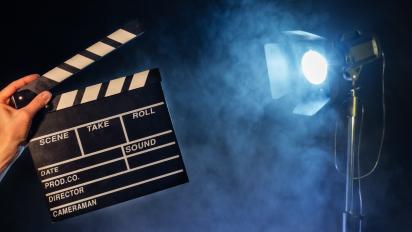 a clapperboard in front of a stage light