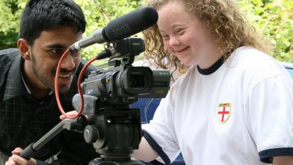 a person teaching another person how to make their own films with a camera