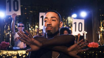a person performing a dance with judges holding up '10' scorecards behind them
